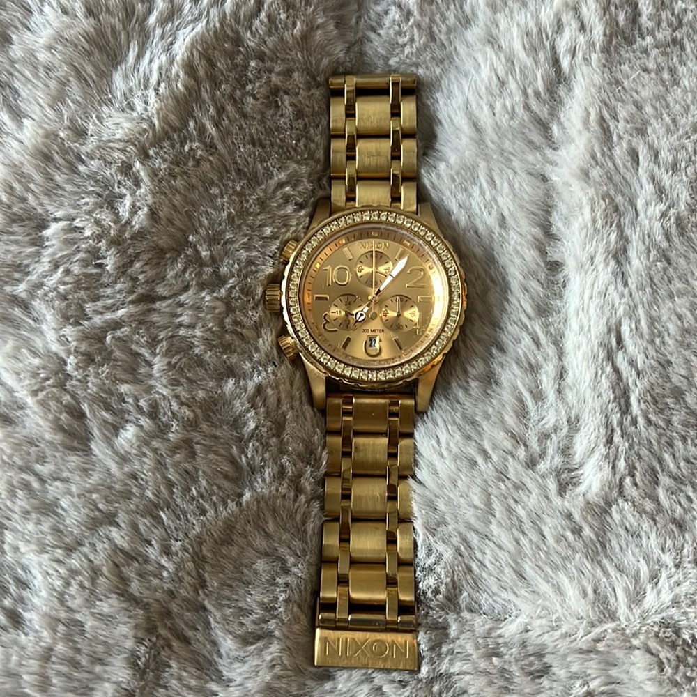 Nixon unisex “diamond” encrusted gold watch